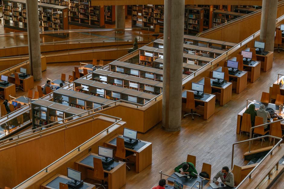 Spacious interior view of Bibliotheca Alexandrina showcasing wooden study areas and computers.