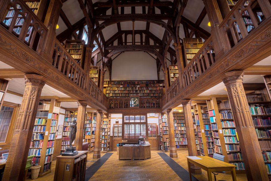 Beautiful interior view of Gladstone's Library, showcasing its wooden architecture and extensive book collection.