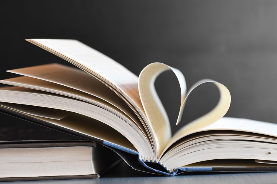 A pile of books with blue covers on a white background, symbolizing education and knowledge.